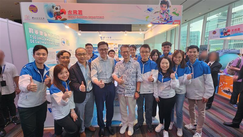 Financial Secretary Paul Chan (front row, sixth left) and Secretary for Innovation, Technology &amp; Industry Professor Sun Dong (front row, fifth left), pictured with WSD’s staff at the booth.